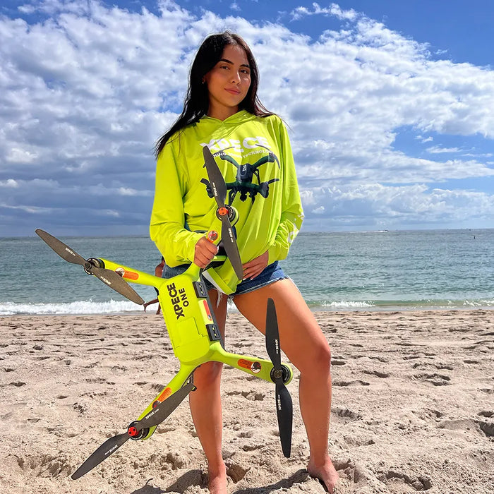 Person holding Xpece ONE fishing drone on a beach